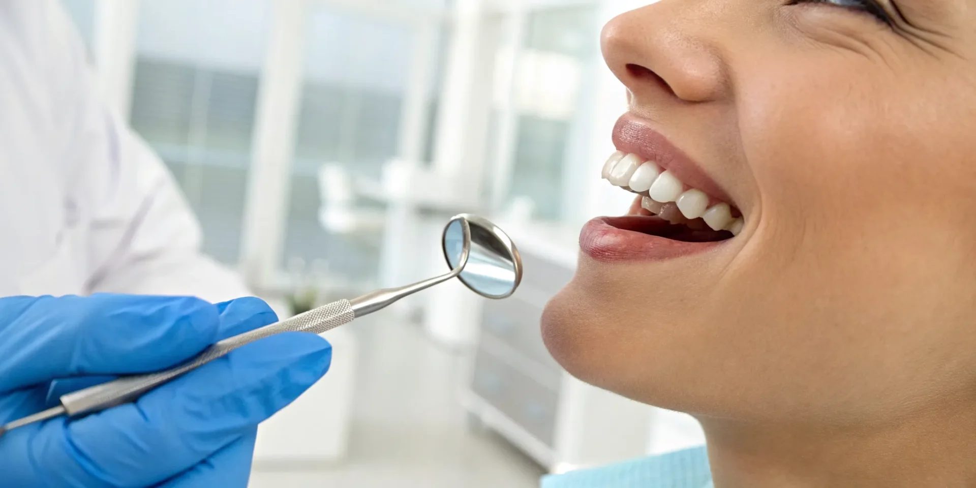 Dentist explaining how much it costs to repair a chipped tooth to a smiling patient.