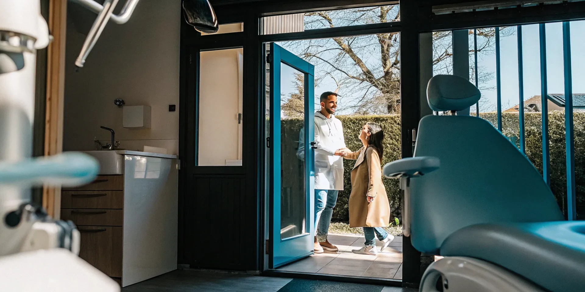 Dentist welcoming a patient for a Saturday appointment