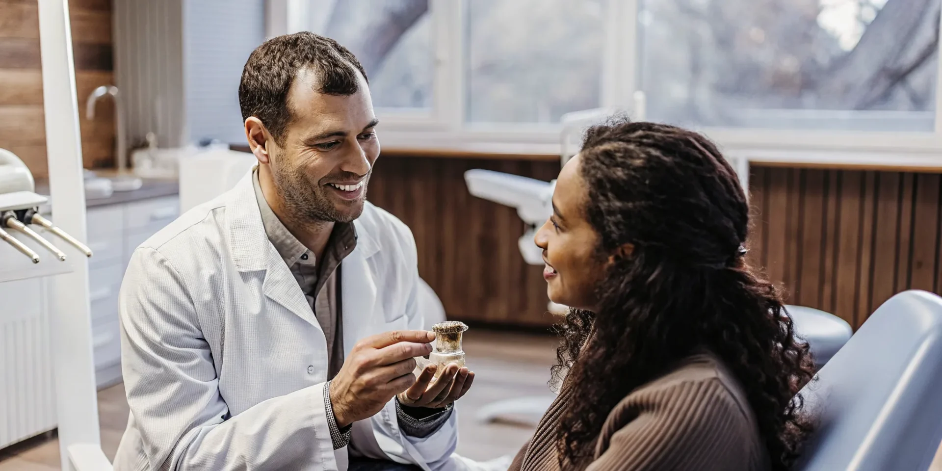 Dentist discussing signs you need a dental crown with a patient