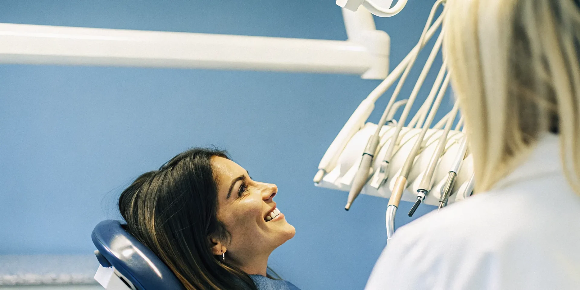 Dental patient smiling with a cosmetic dentist in a modern Lowell, MA dental office