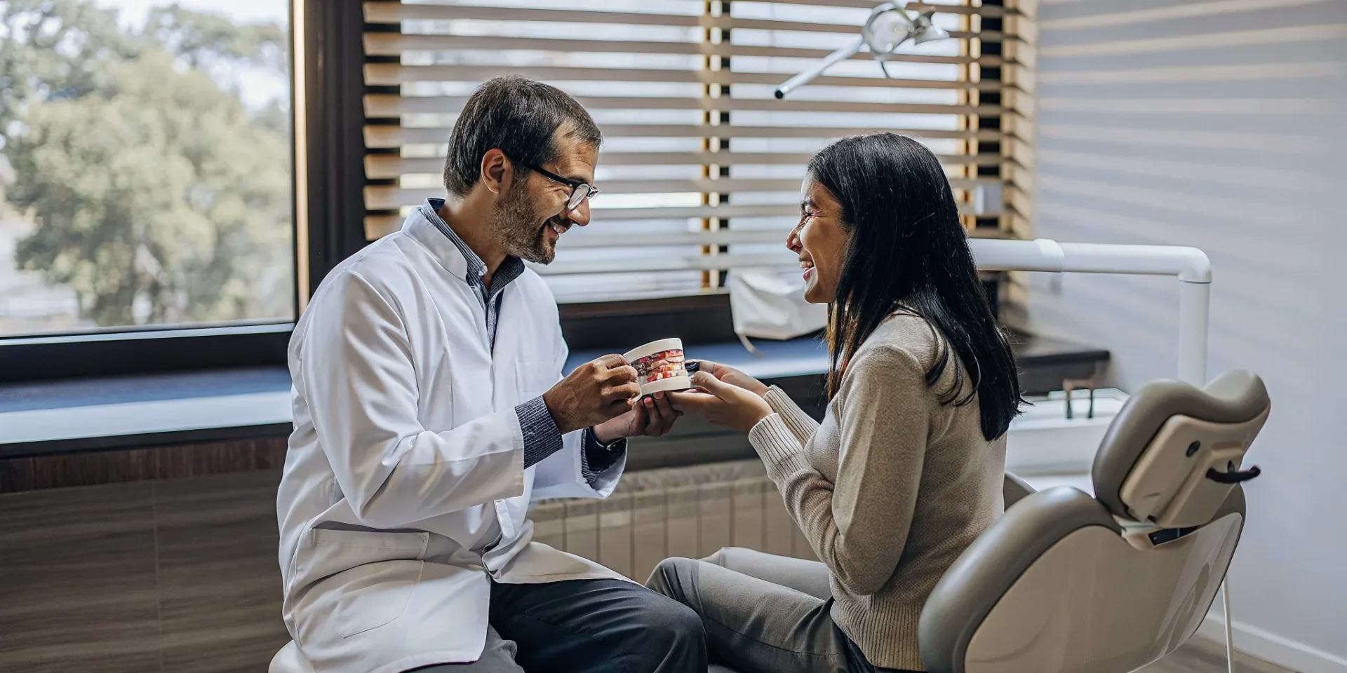Dentist and patient discussing dental implants in a modern Lowell dental office