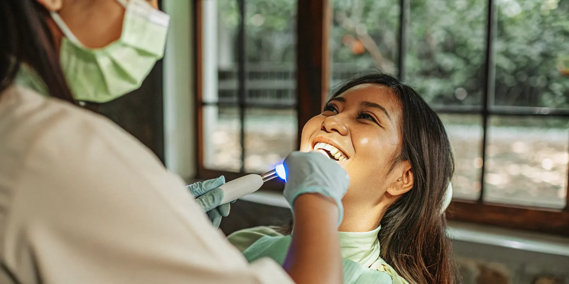 Dental professional preparing a gentle whitening treatment for a patient with sensitive teeth in a modern Lowell dental office