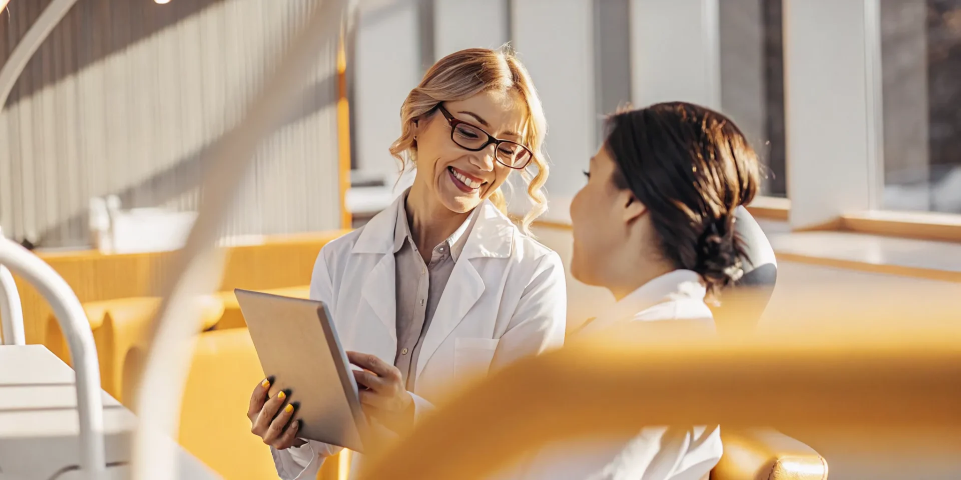Dentist consulting with patient about cosmetic smile options in a modern dental office